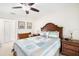 Comfortable guest bedroom with a queen bed, nautical decor, and windows at 12204 Sun Vista W Ct, Treasure Island, FL 33706