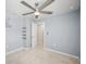 Bedroom with modern ceiling fan, plush carpeting and floating shelves at 12309 Grizzly Ln, New Port Richey, FL 34654