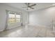 Bright living room featuring tiled floors and large windows that provide an abundance of natural light at 12309 Grizzly Ln, New Port Richey, FL 34654