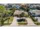 An aerial view of a waterfront home featuring lush landscaping, a spacious driveway, and a serene atmosphere at 1233 Eden Isle Ne Dr, St Petersburg, FL 33704
