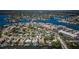 An aerial view captures a mix of residential homes and condominiums nestled along the bay, showcasing vibrant community at 1233 Eden Isle Ne Dr, St Petersburg, FL 33704