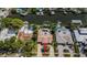 An aerial view of a waterfront home featuring a private pool, lush landscaping, and ample outdoor space for relaxation at 1233 Eden Isle Ne Dr, St Petersburg, FL 33704