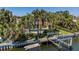 Backyard view of a home featuring a dock, canal, and swimming pool at 1233 Eden Isle Ne Dr, St Petersburg, FL 33704
