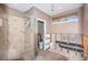 Bathroom featuring a walk-in shower and a window with a woven shade at 1233 Eden Isle Ne Dr, St Petersburg, FL 33704