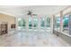 Spacious living room with large windows and doors overlooking the pool at 1233 Eden Isle Ne Dr, St Petersburg, FL 33704