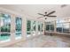 Bright living room featuring poolside access and abundant natural light at 1233 Eden Isle Ne Dr, St Petersburg, FL 33704