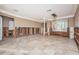 Spacious living room with marble floors and recessed lighting, ready for renovation at 1233 Eden Isle Ne Dr, St Petersburg, FL 33704