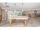 Large living room with marble floors and french doors to an enclosed lanai, ready for renovation at 1233 Eden Isle Ne Dr, St Petersburg, FL 33704