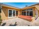 Covered patio area featuring a seating bench, pavers, and windows at 1233 Eden Isle Ne Dr, St Petersburg, FL 33704