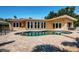 Backyard pool and patio featuring a kidney bean shaped pool with pavers at 1233 Eden Isle Ne Dr, St Petersburg, FL 33704