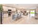 Open concept kitchen with island, white cabinets, and tile flooring open to the dining and living areas at 12960 Conquistador Loop, Spring Hill, FL 34610