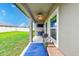 Covered back patio with a ceiling fan, outdoor seating, and a beautiful view of the fenced backyard at 12960 Conquistador Loop, Spring Hill, FL 34610