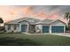 Charming single-story home with a well-manicured lawn and a three-car garage, perfect for modern living at 13298 High Springs Ave, Port Charlotte, FL 33981