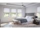 Serene bedroom with large windows, neutral tones, and a ceiling fan, creating a tranquil retreat at 13298 High Springs Ave, Port Charlotte, FL 33981