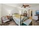 Bedroom featuring a decorative ceiling fan, a fireplace, and a doorway to a walk-in closet at 14407 Alistar Manor Dr, Wimauma, FL 33598