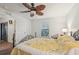 Bedroom featuring a decorative ceiling fan, natural light, and a door to the outdoor patio at 14407 Alistar Manor Dr, Wimauma, FL 33598