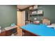 Craft room with a large blue cutting table, shelving, and wood-look floors at 14407 Alistar Manor Dr, Wimauma, FL 33598