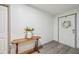 Bright entryway featuring wood-look floors, table with a vase of flowers, and decorative wreath at 14407 Alistar Manor Dr, Wimauma, FL 33598