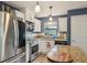 Bright kitchen features stainless steel appliances, granite countertops, and white cabinets at 14407 Alistar Manor Dr, Wimauma, FL 33598