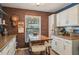 Warm kitchen nook with exposed brick, bright countertops and natural light at 14407 Alistar Manor Dr, Wimauma, FL 33598