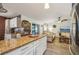 Inviting living room flowing from kitchen boasts lots of natural light and vinyl floors at 14407 Alistar Manor Dr, Wimauma, FL 33598