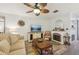 Comfortable living room with neutral tones, decorative fireplace, and vinyl flooring at 14407 Alistar Manor Dr, Wimauma, FL 33598