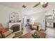 Cozy living room features a decorative fireplace, wood floors, and open access to the kitchen at 14407 Alistar Manor Dr, Wimauma, FL 33598