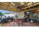 Undercover outdoor kitchen and dining area features grill, beverage fridge, and ceiling fan at 14407 Alistar Manor Dr, Wimauma, FL 33598
