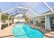 Inviting screened-in pool featuring brick paving, outdoor seating, and a tranquil setting at 1479 Arredondo St, North Port, FL 34286