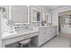 Stylish bathroom vanity area with double sinks, makeup vanity and illuminated mirrors at 15 Avalon St # 601, Clearwater Beach, FL 33767