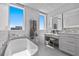 Bright bathroom featuring a soaking tub, makeup vanity, and natural light at 15 Avalon St # 601, Clearwater Beach, FL 33767