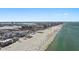 Picturesque coastal view of beachside condo with beachgoers, white sand, and ocean at 15 Avalon St # 601, Clearwater Beach, FL 33767
