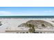 Stunning beach and ocean view from condo balcony, with palm trees and cars below at 15 Avalon St # 601, Clearwater Beach, FL 33767