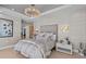 Tastefully decorated bedroom featuring a tray ceiling, sophisticated décor, and elegant furnishings at 15 Avalon St # 601, Clearwater Beach, FL 33767