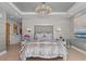 Well-lit bedroom featuring contemporary decor, sophisticated lighting, and a tray ceiling design at 15 Avalon St # 601, Clearwater Beach, FL 33767