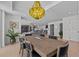 Open dining area features contemporary table and chairs, an eclectic chandelier and an open floor plan at 15 Avalon St # 601, Clearwater Beach, FL 33767