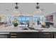 Bright, modern kitchen with an island, a wine cooler, and beautiful views of the beach at 15 Avalon St # 601, Clearwater Beach, FL 33767