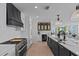 Modern kitchen featuring stainless steel appliances, custom cabinets, and contrasting black and white design elements at 15 Avalon St # 601, Clearwater Beach, FL 33767
