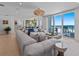 Spacious living area with a large couch and a beautiful view of the ocean and beach at 15 Avalon St # 601, Clearwater Beach, FL 33767