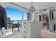 Bright walk-in closet with crystal chandelier and views of the beach at 15 Avalon St # 601, Clearwater Beach, FL 33767