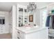 Bright walk-in closet with crystal chandelier, glass display shelving, and custom drawers at 15 Avalon St # 601, Clearwater Beach, FL 33767