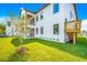 Beautiful home backyard featuring lush green grass, a modern exterior and a staircase at 1741 Nevada Ne Ave, St Petersburg, FL 33703