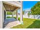 Spacious backyard with a covered patio, green lawn, and white fence at 1741 Nevada Ne Ave, St Petersburg, FL 33703