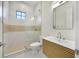 Modern bathroom featuring a glass shower, stylish vanity and light fixtures at 1741 Nevada Ne Ave, St Petersburg, FL 33703