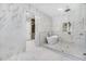 Elegant bathroom with marble accents, freestanding tub, walk-in shower, and access to the closet at 1741 Nevada Ne Ave, St Petersburg, FL 33703
