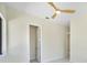 Bright bedroom with a ceiling fan, marble floors, and an open doorway at 1741 Nevada Ne Ave, St Petersburg, FL 33703