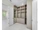 Large walk-in closet with custom shelves, drawers, and mirrors at 1741 Nevada Ne Ave, St Petersburg, FL 33703