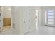 Bright foyer with white marble floors and a view of the front door and other rooms at 1741 Nevada Ne Ave, St Petersburg, FL 33703