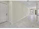 Spacious hallway featuring white marble floors and access to various rooms in the home at 1741 Nevada Ne Ave, St Petersburg, FL 33703