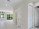 Open hallway with white marble floors leading to a bright living area and closet space at 1741 Nevada Ne Ave, St Petersburg, FL 33703